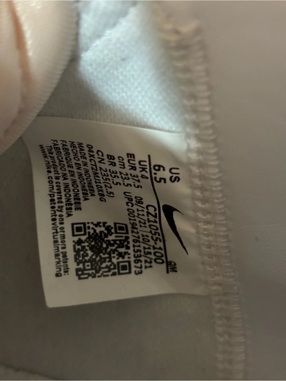 Nike White High-Top Sneakers with Black Swoosh and Yellow Tongue